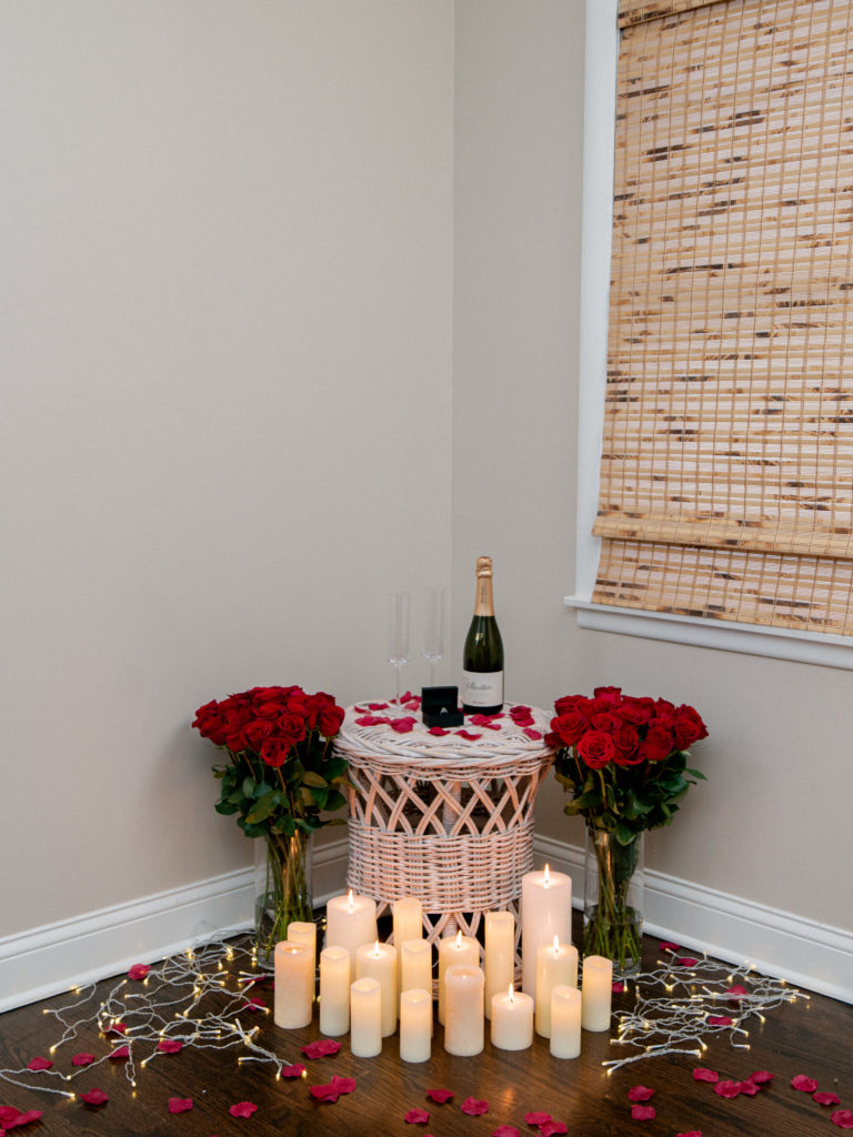 proposal set in home with engagement ring and champagne flutes