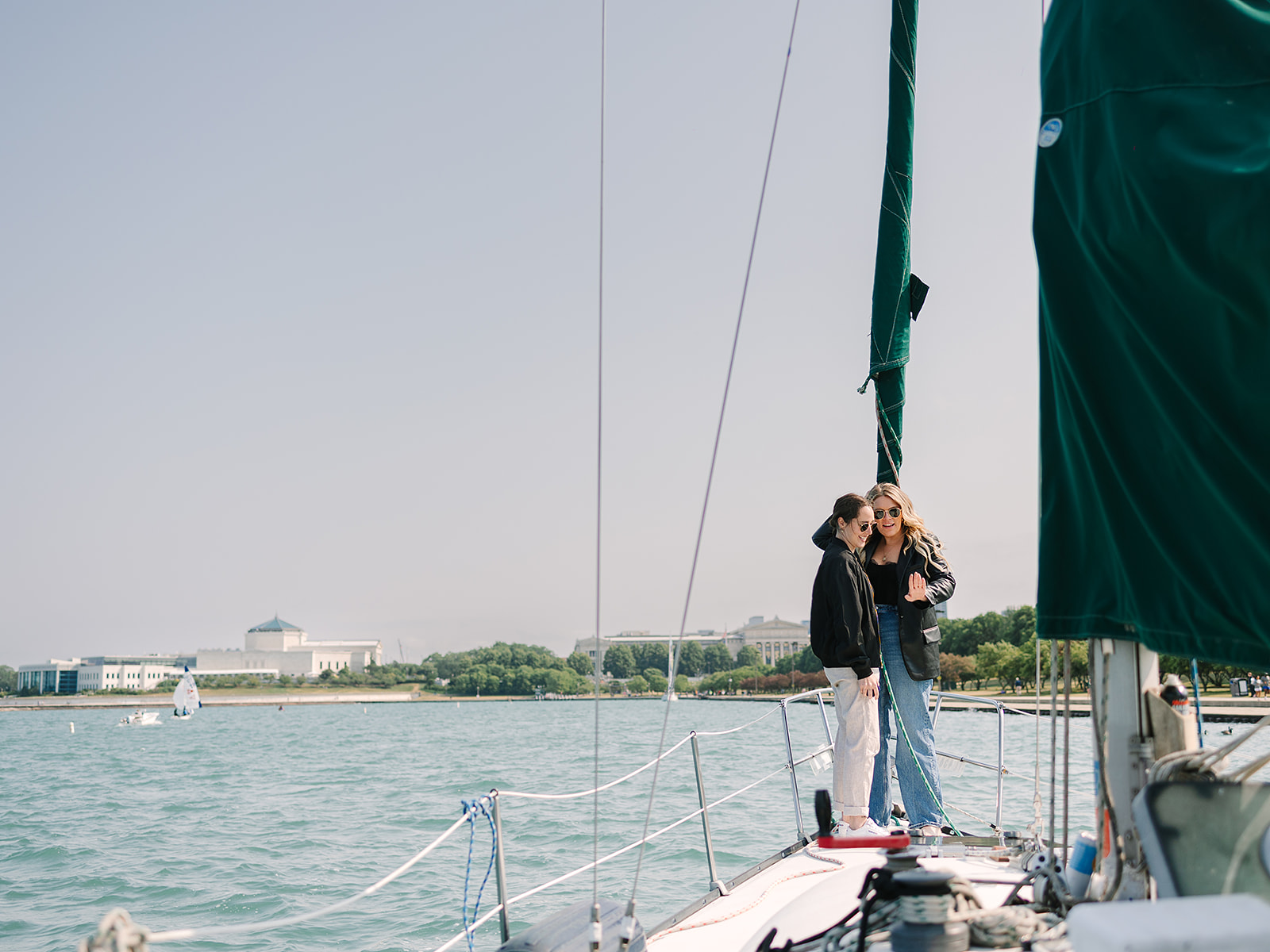 Newly engaged couple moments after saying yes on Lake Michigan