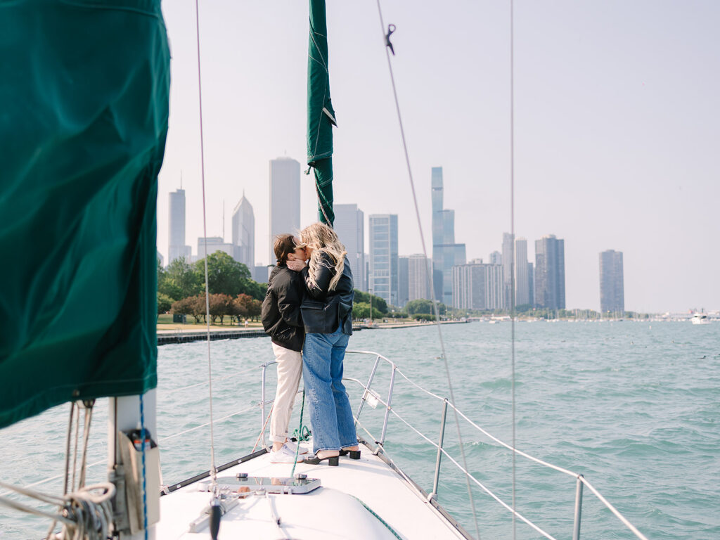 Newly engaged couple on the water with the downtown Chicago skyline
