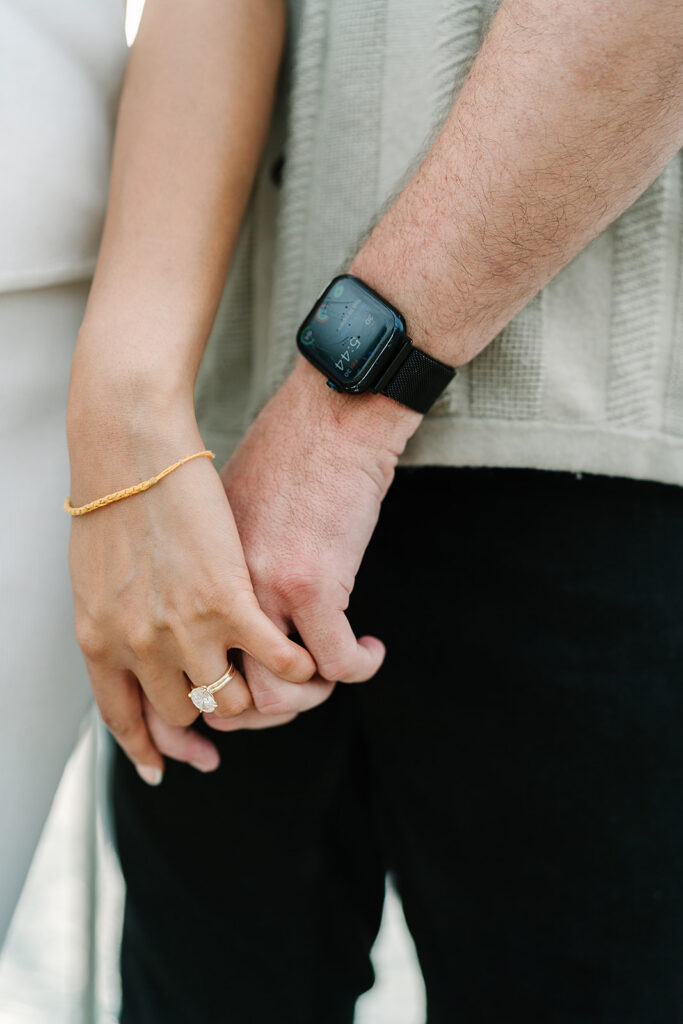 Couple holding hands during engagement portraits