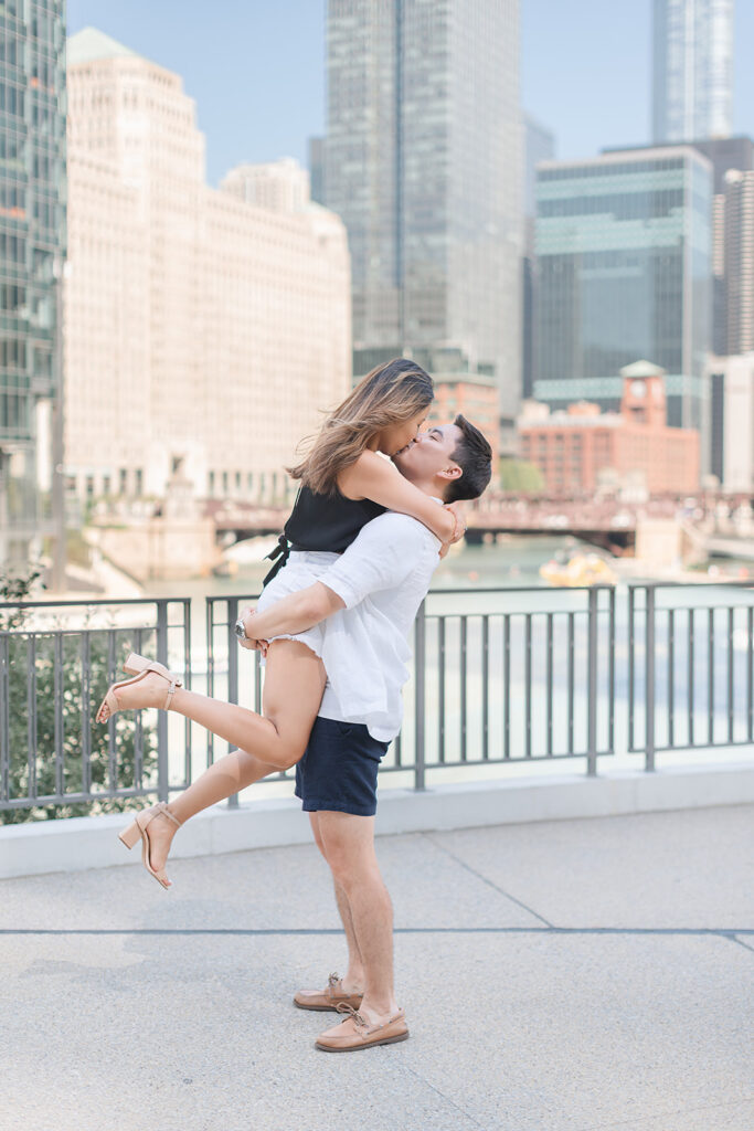 Newly engaged couple at River Point Park with the El tracks behind them